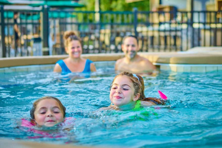 Kids and family having fun in pool